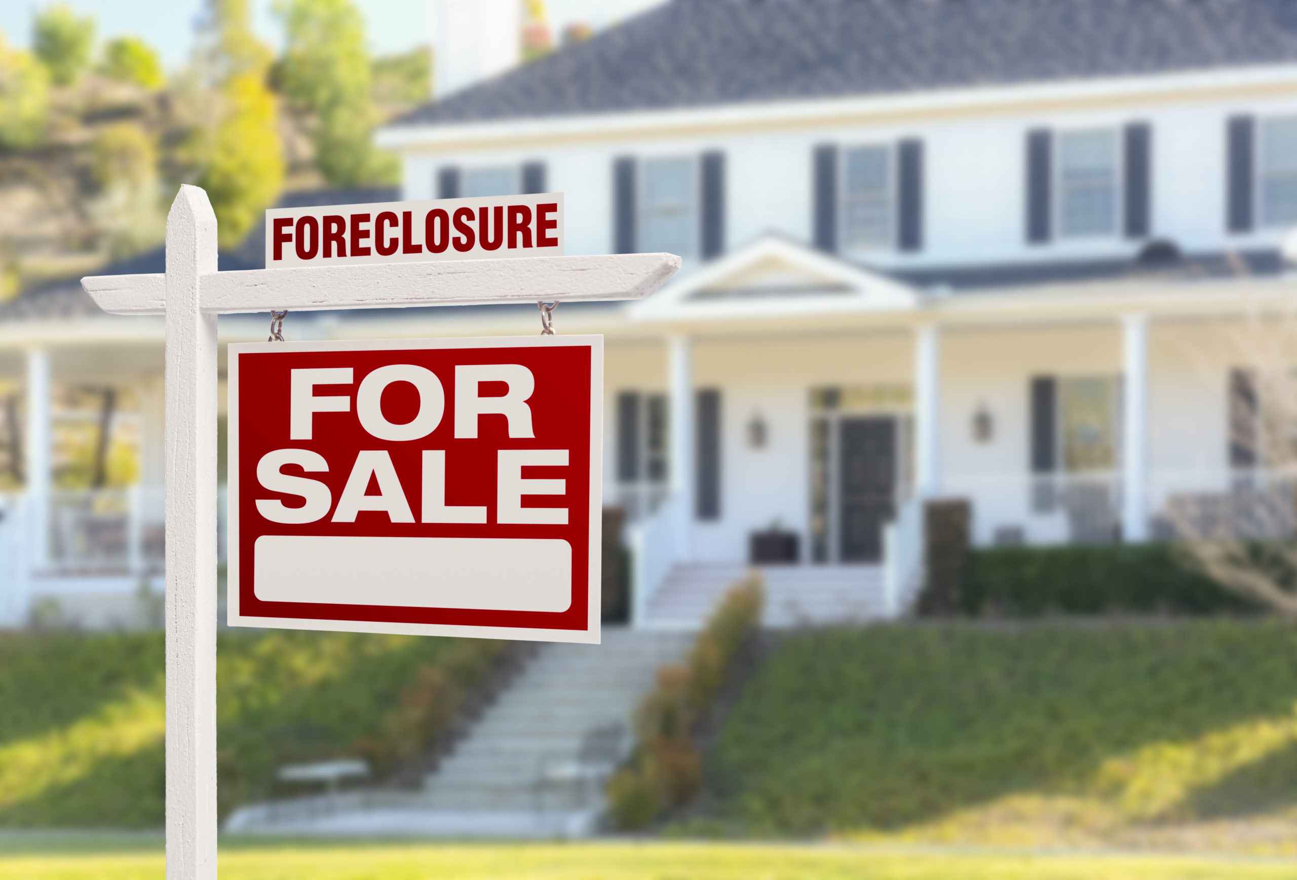 house with foreclosure sign