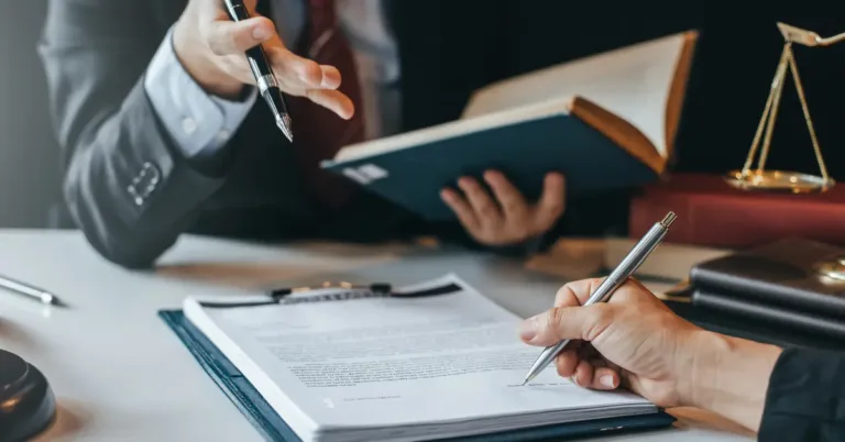 Litigator reviewing legal case documents with a client during a legal consultation.