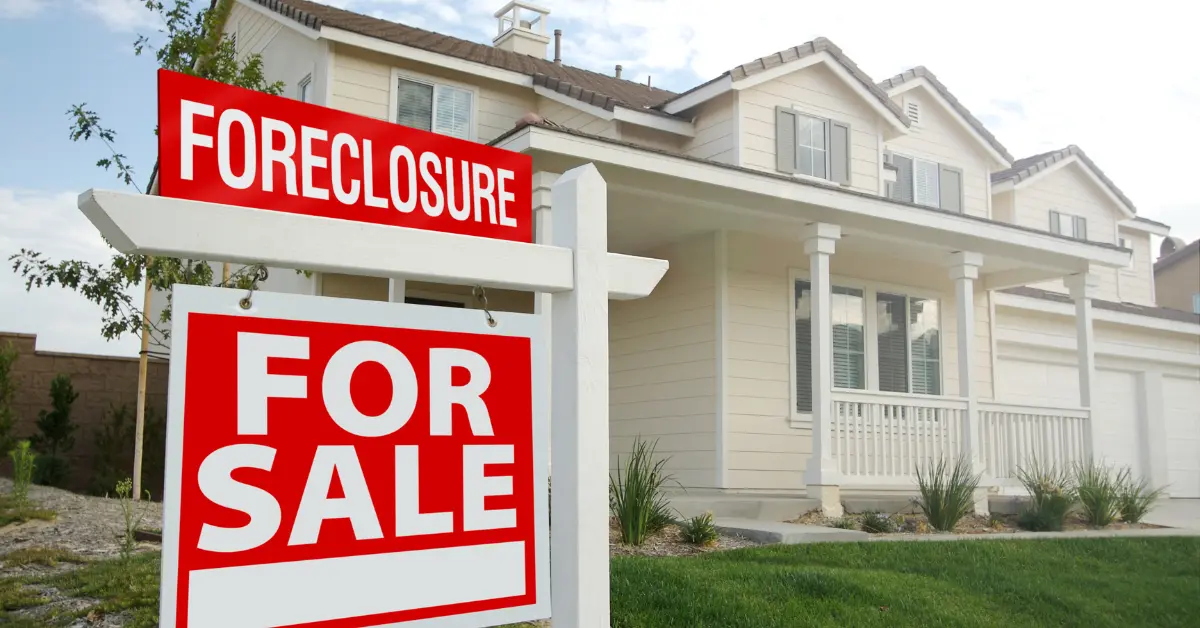 White house with foreclosure and for sale signs in front yard, representing a property in foreclosure in Texas