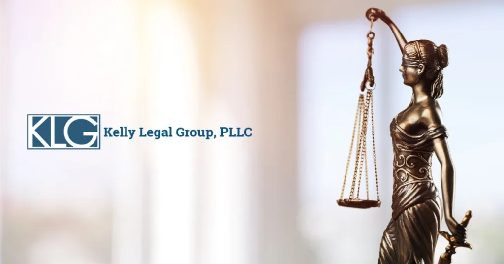 Kelly Legal Group, PLLC logo next to bronze statue of Lady Justice holding scales, symbolizing law and fairness.