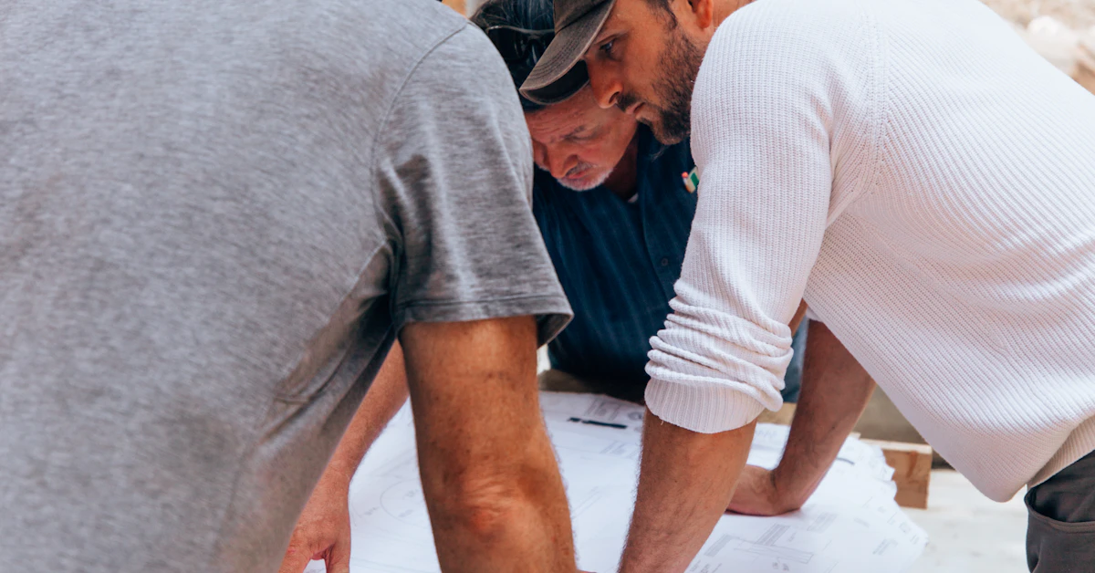 Contractors reviewing project plans on a Texas job site, protected by the Texas Payment Act